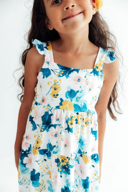 Girl wearing Blooming Buttercups print maxi dress with shoulder ruffles and back cutout