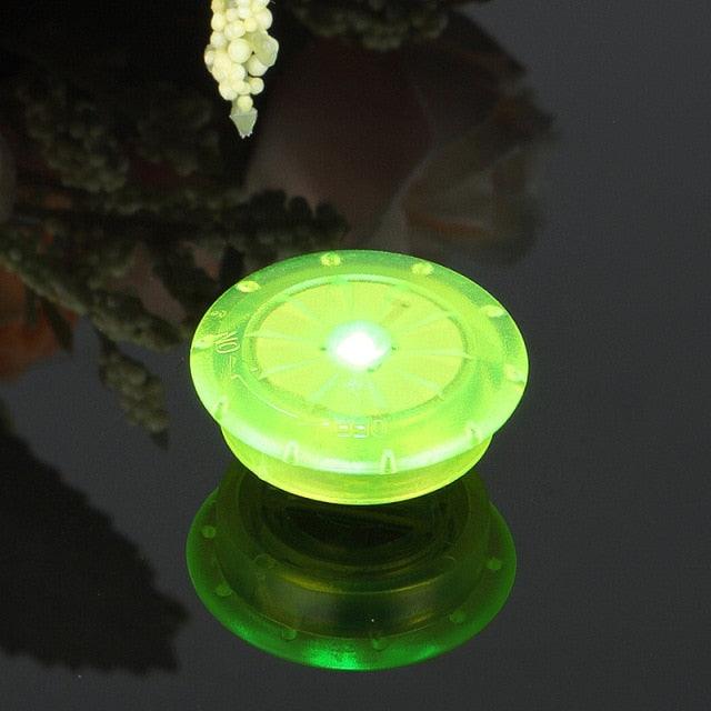 Small, vibrant LED bike spoke lights in red, blue, and green attached to a bicycle wheel frame.