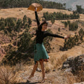 A unique, knee-length mini wrap skirt made from colorful reclaimed sari fabric styled for a casual look.