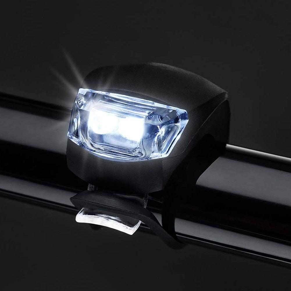 3-mode waterproof silicone bike light set attached to a bicycle handlebar and frame.