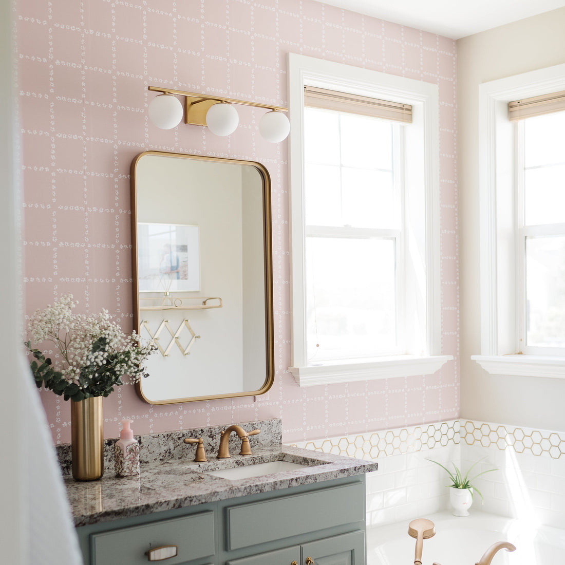 Close up of Shae geometric wallpaper with soft blush pink dashed grid lines on a white background in a modern bedroom setting.