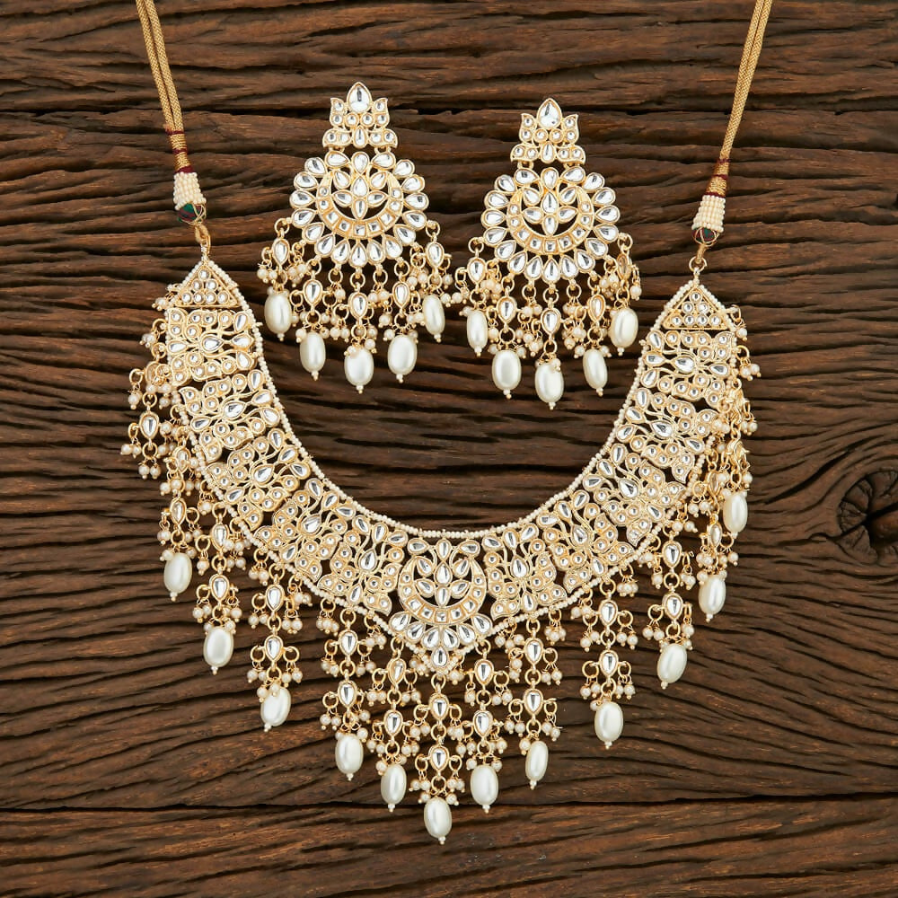 3-piece Golden White jewelry set featuring Kundan, pearls, and Onyx stone accents.