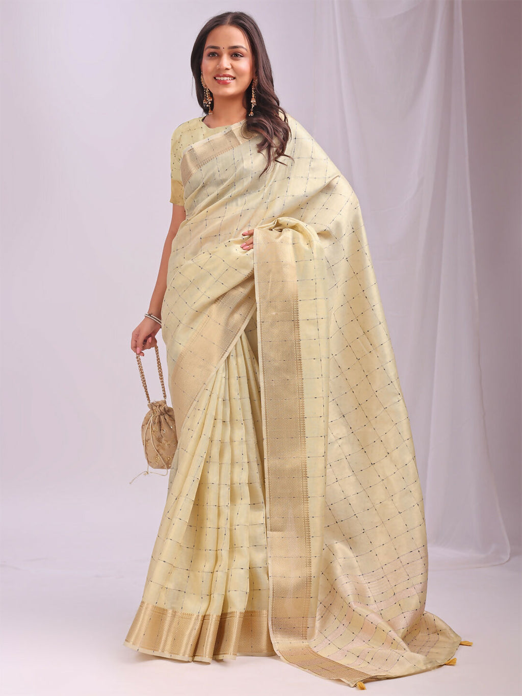 Elegant gold organza saree featuring a yellow blouse, perfect for festive events.
