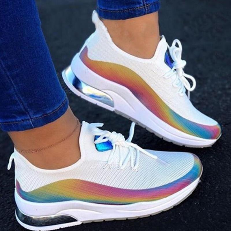 Women's white lace-up fashion sneakers with breathable mesh upper and vulcanized flat sole.