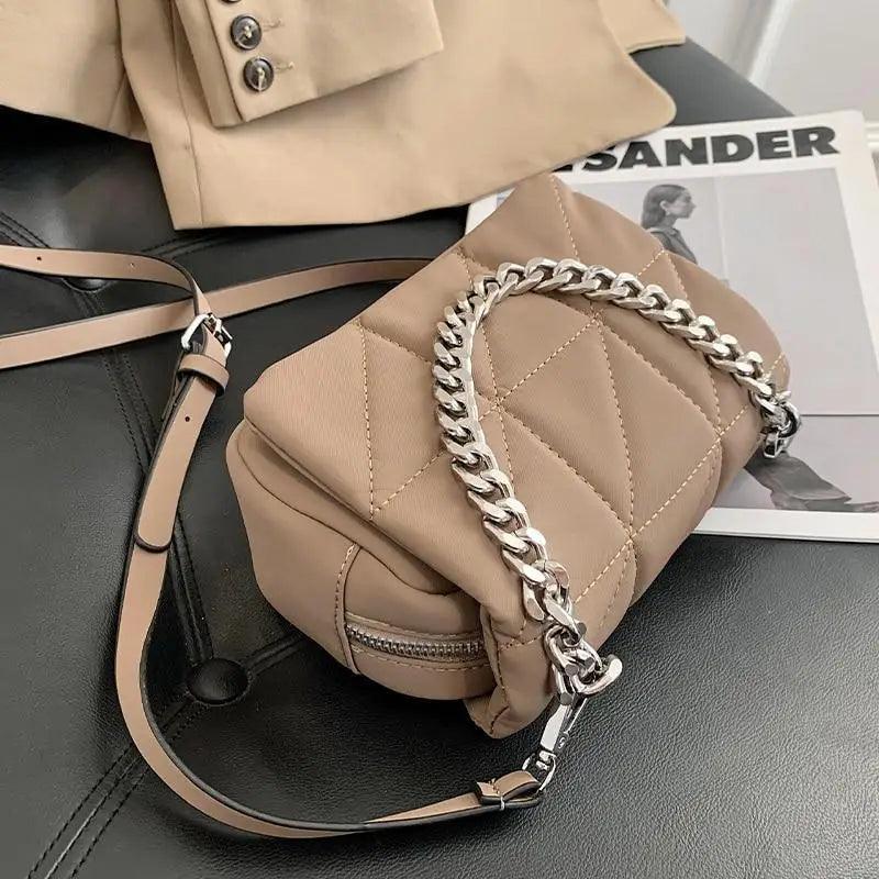 Mini designer-style nylon crossbody bag for kids featuring a decorative gold metal chain shoulder strap