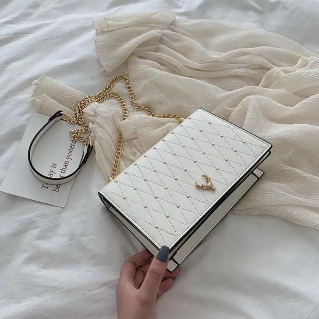 Modern geometric pattern PU leather crossbody bag with a designer chain strap in white, black, and yellow