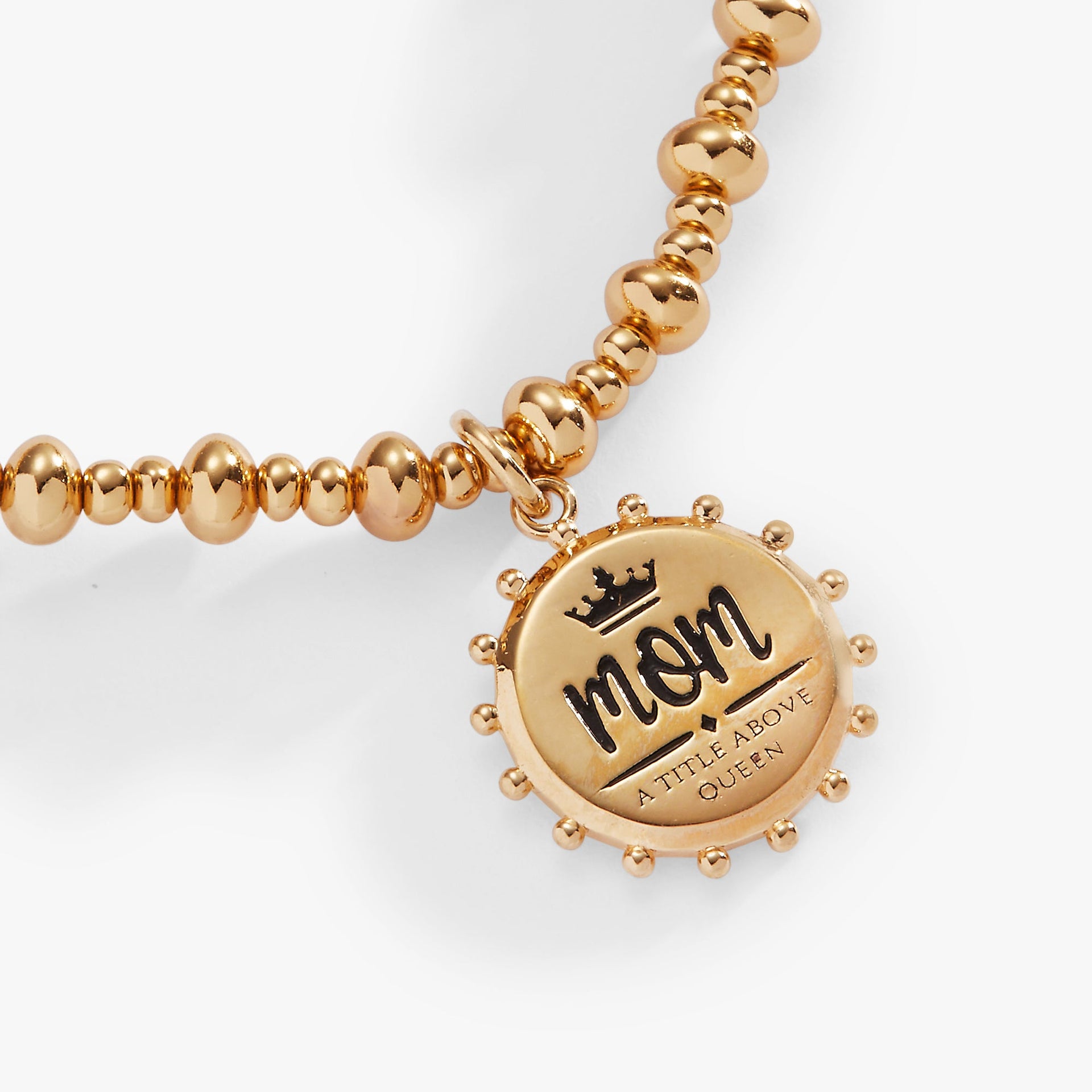Gold-tone beaded stretch bracelet with a charm reading Mom, A Title Above Queen with a crown icon.