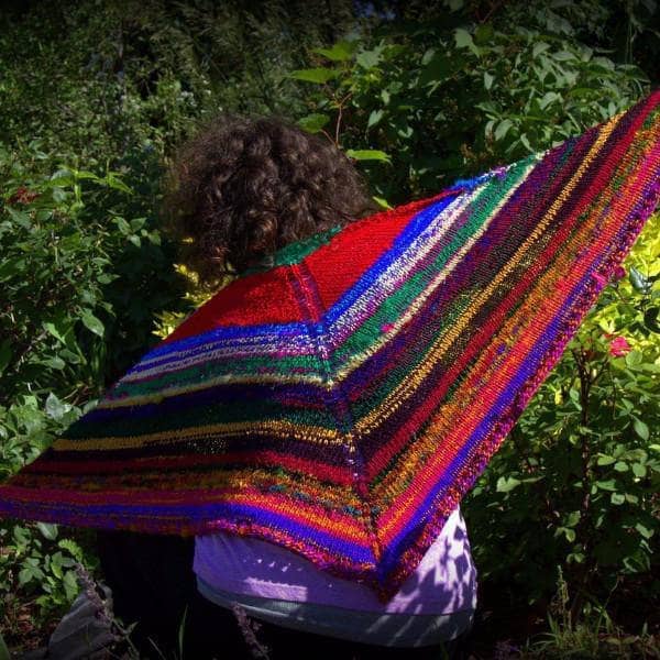 Hand-knit Moment of Zen shawl draped over a chair