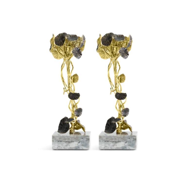 Set of gold and grey Monet's Garden sunset candleholders on a neutral background