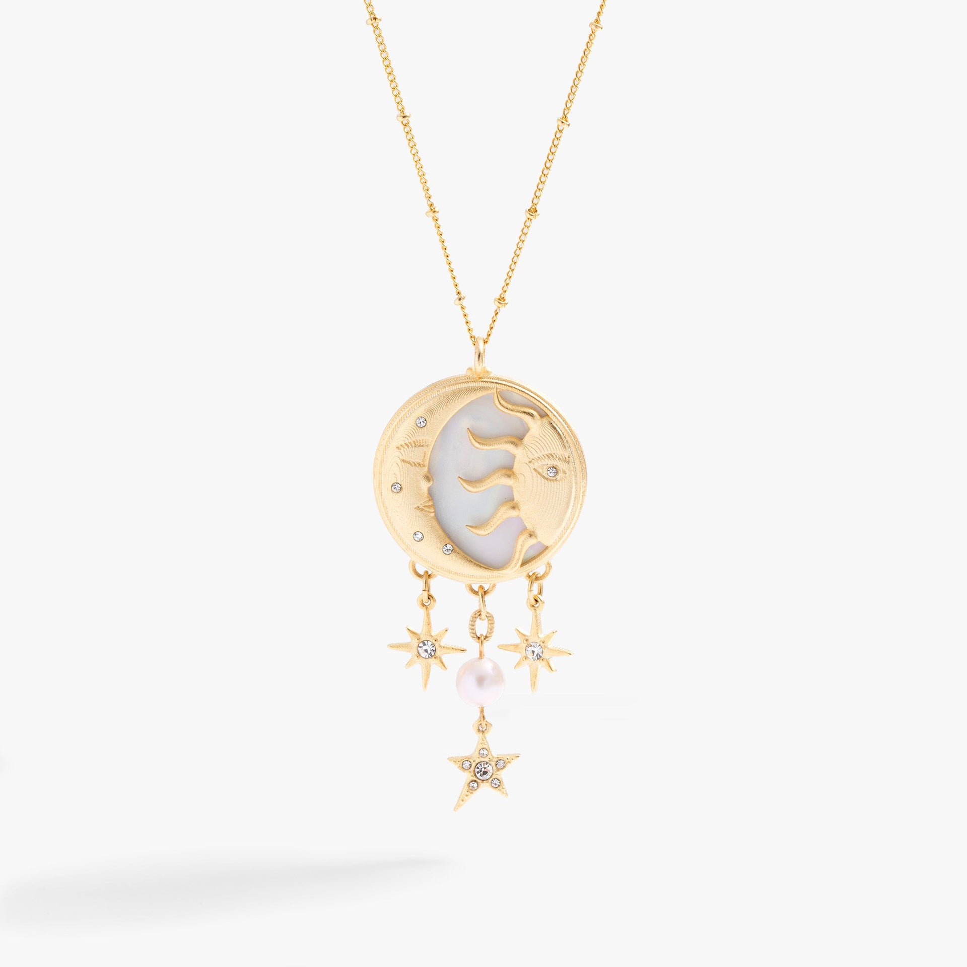 Gold-tone crescent moon and sun pendant necklace with Mother of Pearl and crystals