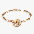 Gold open-link chain bracelet with a mother of pearl starburst charm and toggle clasp