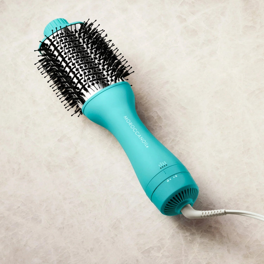 Moroccanoil Effortless Style 4-in-1 Blow-Dryer Brush styling hair to achieve a smooth blowout