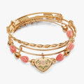 Set of three gold and pink floral bracelets including a MOM charm bangle and tulip bracelet