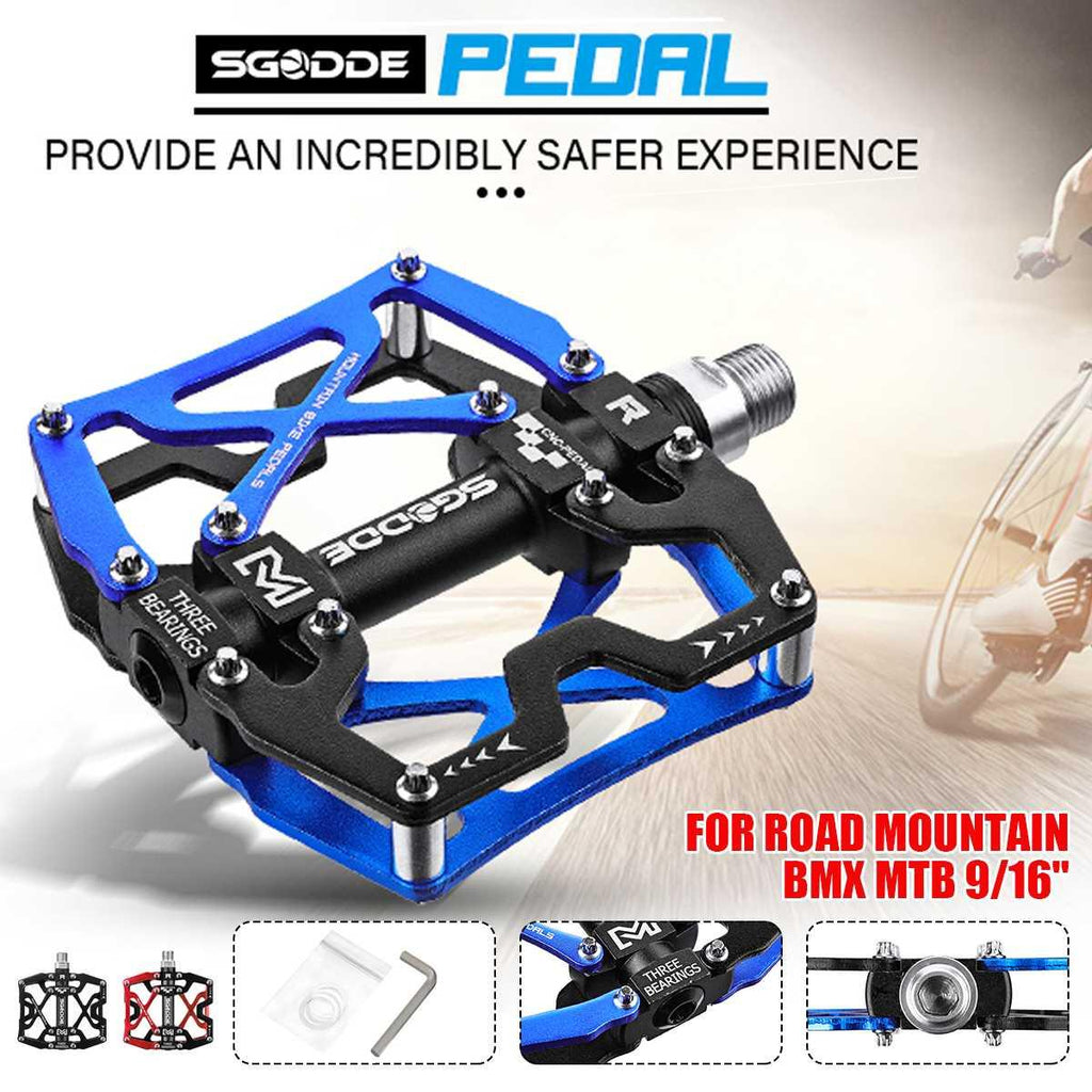 A pair of ultralight aluminum wide platform bike pedals in black and blue.