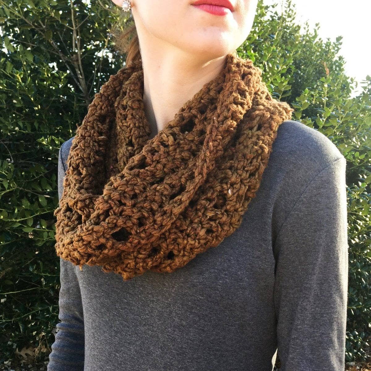 Close up of a chunky brown and purple handmade Mountain Mobius cowl worn with a bohemian style outfit