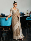 An elegant beige woven linen saree with a contrast zari border and tassel detailing.