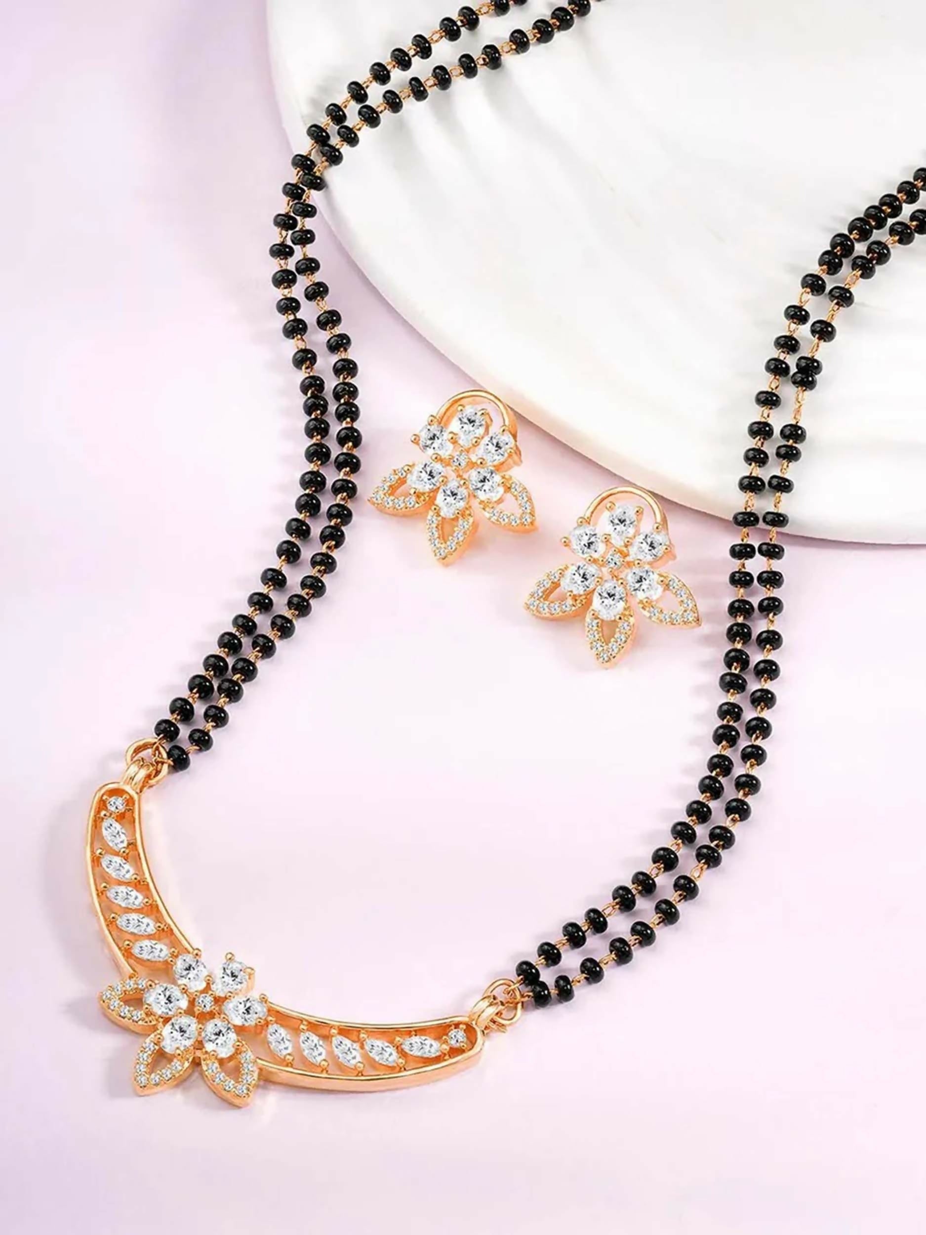 Traditional golden Mangalsutra necklace with matching earrings featuring black and white details