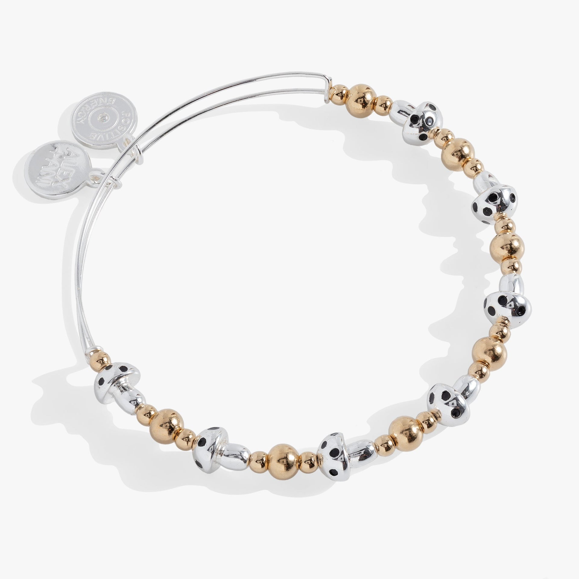 Silver mushroom beaded bangle with gold spacer beads on a studio background.