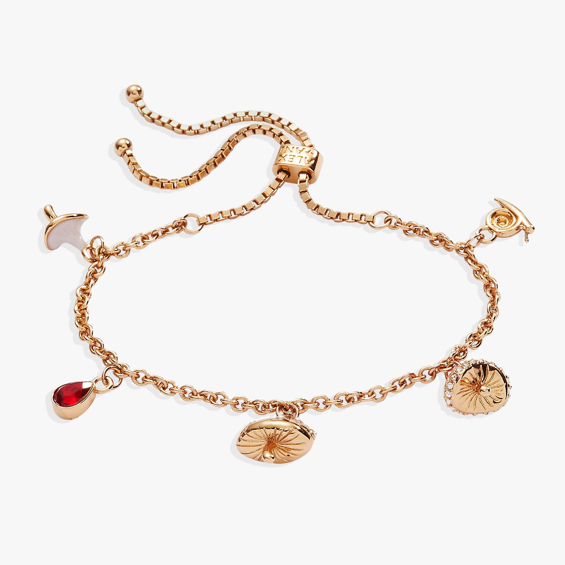 Whimsical gold-tone bolo charm bracelet with mushroom, snail, and red crystal charms