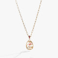 Gold circle pendant necklace featuring whimsical mushroom charms and a ruby-red crystal accent ring