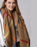 Oversized square scarf featuring a black and white windowpane plaid pattern with frayed edges
