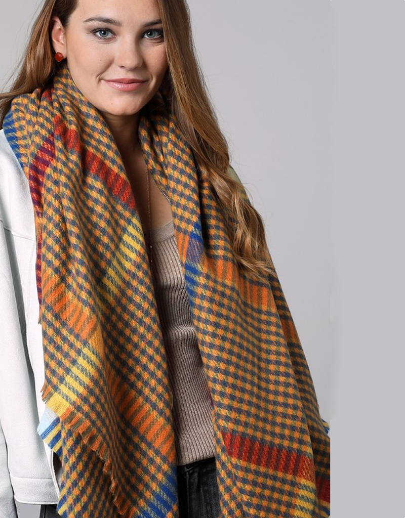 Oversized square scarf featuring a black and white windowpane plaid pattern with frayed edges
