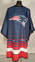 New England Patriots themed barber cape with stainless steel snap closure and vibrant team branding.