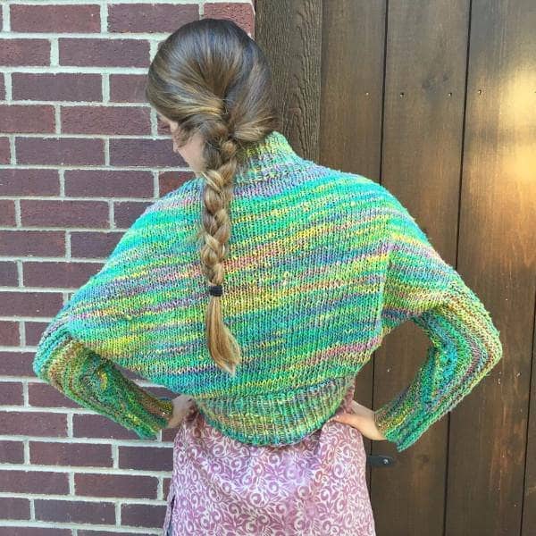 Mystic Mountain Shrug Kit featuring colorful roving silk yarn skeins and a knitting pattern.