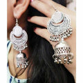 Classic oxidized silver jhumka earrings with traditional mirror work detail.