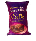A novelty throw cushion shaped like a Cadbury Silk chocolate bar in purple and gold, perfect for kids room decor.