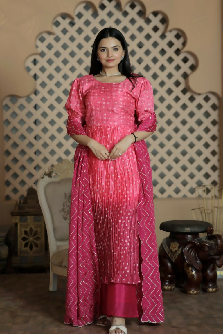 Pink muslin floral print kurta with crush pleating and puff sleeves, paired with trousers and dupatta.