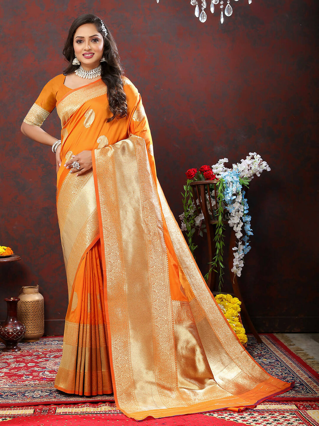Bright orange soft silk saree with gold zari woven patterns and matching blouse