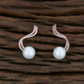 Pair of elegant Golden White brass earrings featuring shimmering American Diamond stones.