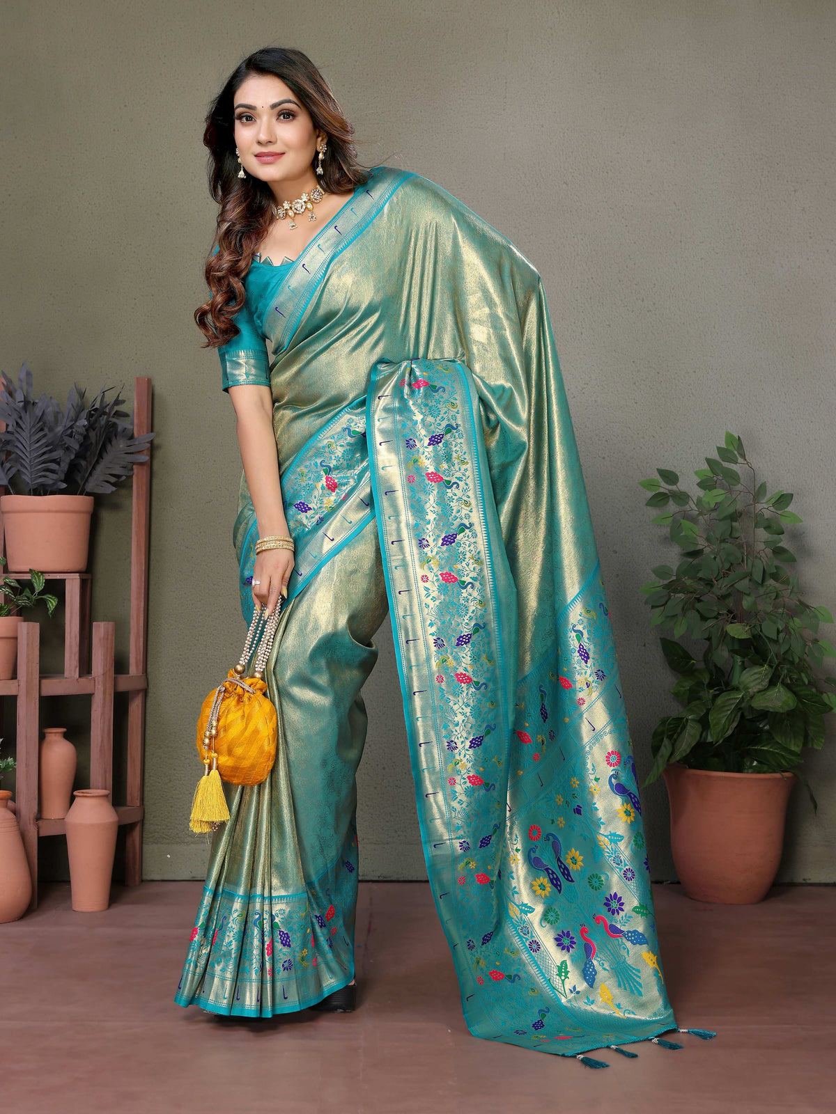 Sea green tissue silk saree with intricate traditional Paithani woven borders.