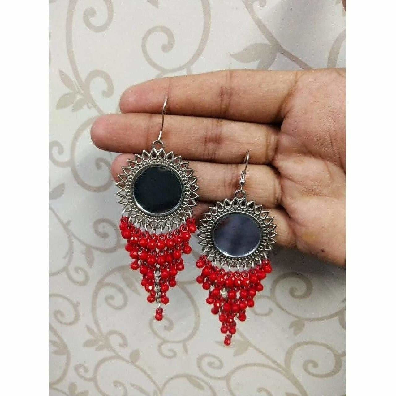 Oxidized silver long drop earrings with sun design and red pearls