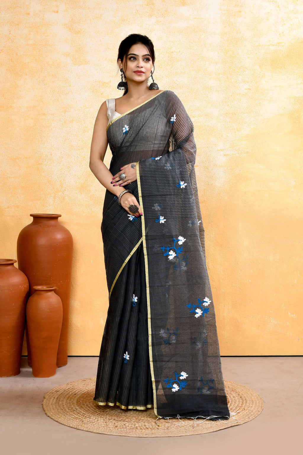 Grey cotton blend saree featuring intricate embroidery and embellishments