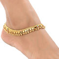 A pair of gold-polished white metal traditional Indian ethnic anklets for women.
