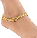 Close-up of gold-polished white metal traditional ethnic foot chain.