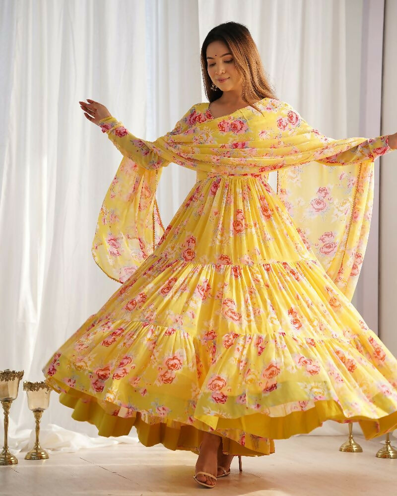 Woman wearing a vibrant yellow georgette kurta set with intricate sequence embroidery work and matching dupatta