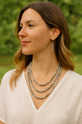 Handcrafted 3-tier Job's Tears seed necklace featuring natural grey, white, and brown seeds in a bohemian style.