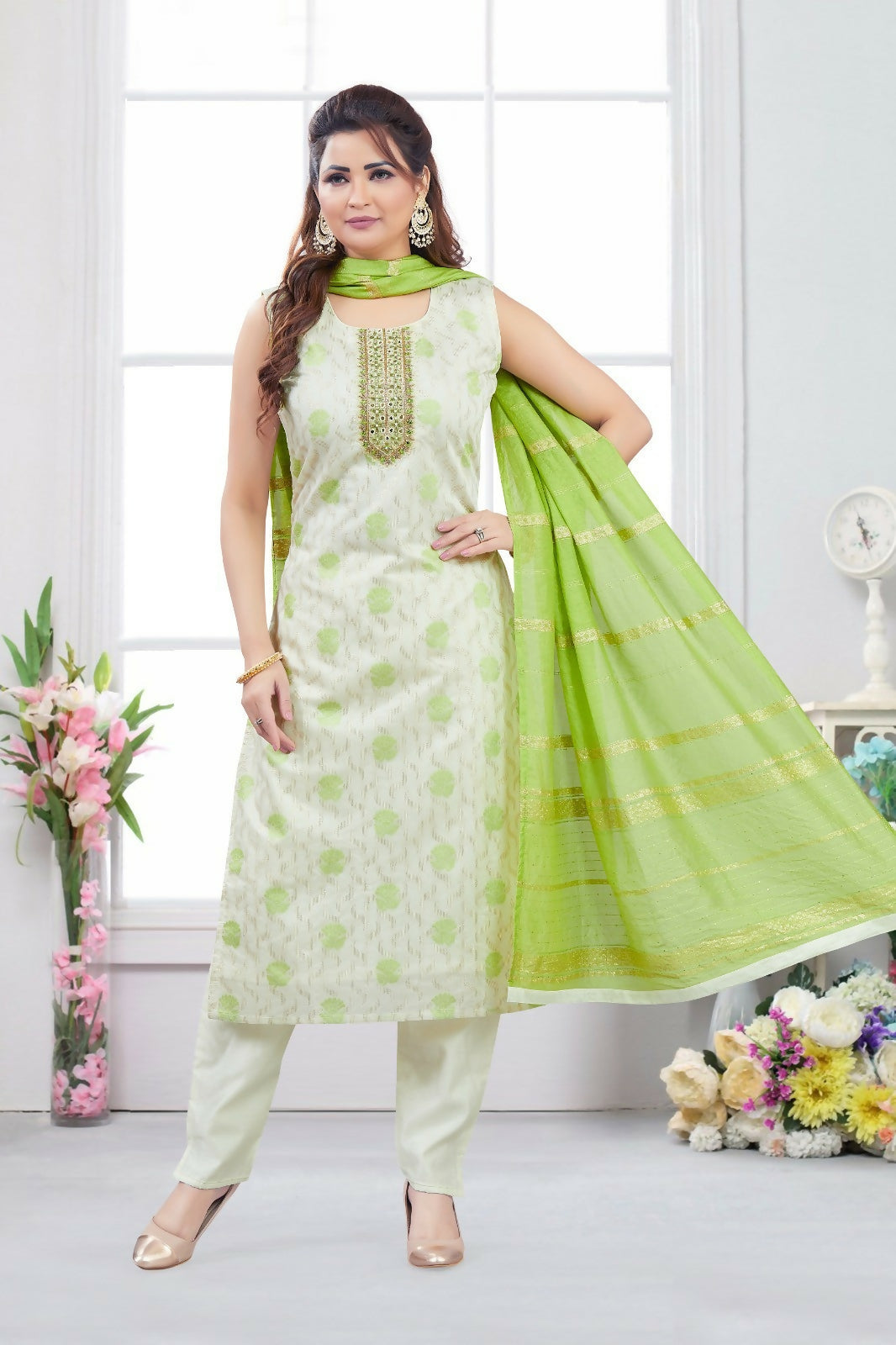 Woman wearing a cream jacquard kurta set with a contrasting green dupatta