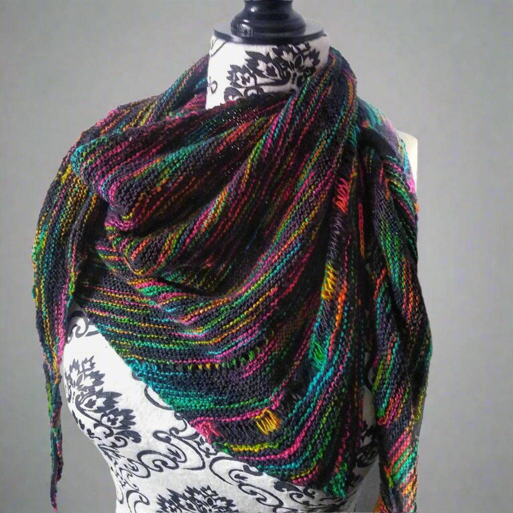 Neon Pop Shawl Knitting Pattern featuring a dark shawl with vibrant rainbow color details.