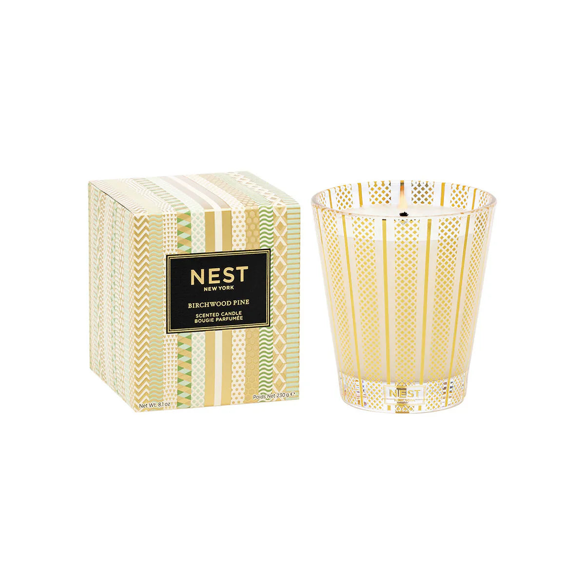 Birchwood Pine scented candle in a gold and green geometric patterned glass vessel