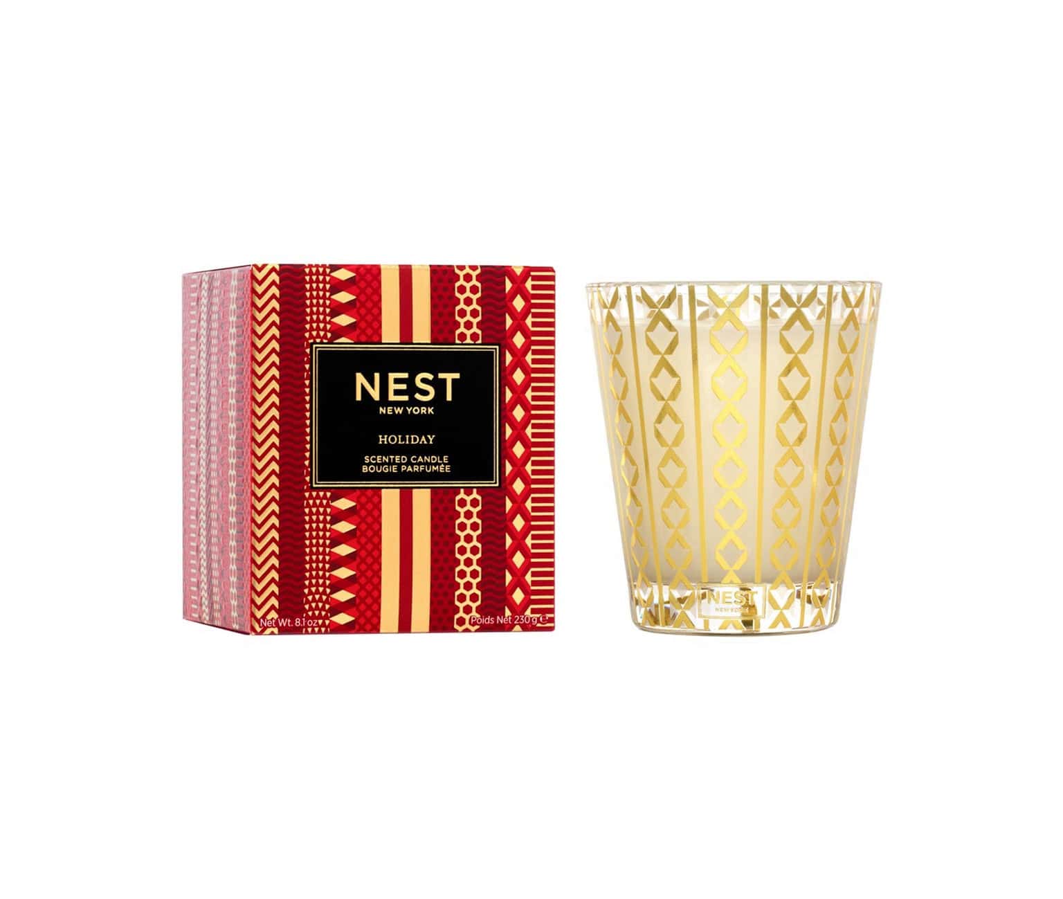 Nest New York Holiday Candle in a festive metallic gold glass vessel sitting on a wooden surface.