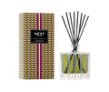 NEST New York Pistachio and Wild Fig Reed Diffuser in a glass bottle with olive green and plum geometric print and gold accents.