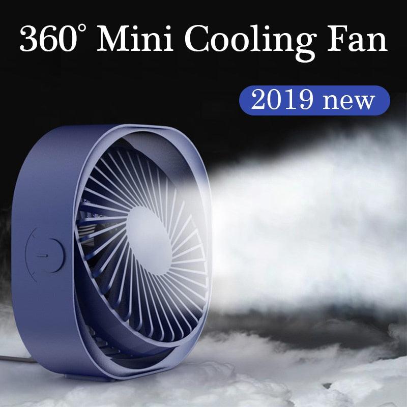 A minimalist 360-degree tilt desk fan in soft blue and pink, perfect for modern office decor.