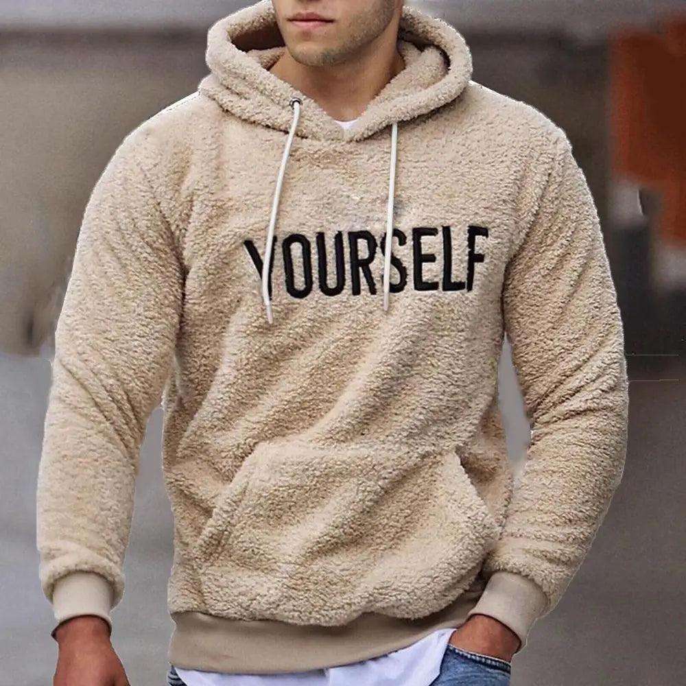 Men wearing a solid color knit hooded sweatshirt with embroidered letter detail.