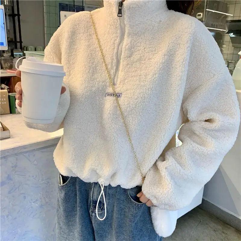 Women wearing a cozy oversized imitation lamb fleece hoodie for autumn and winter.
