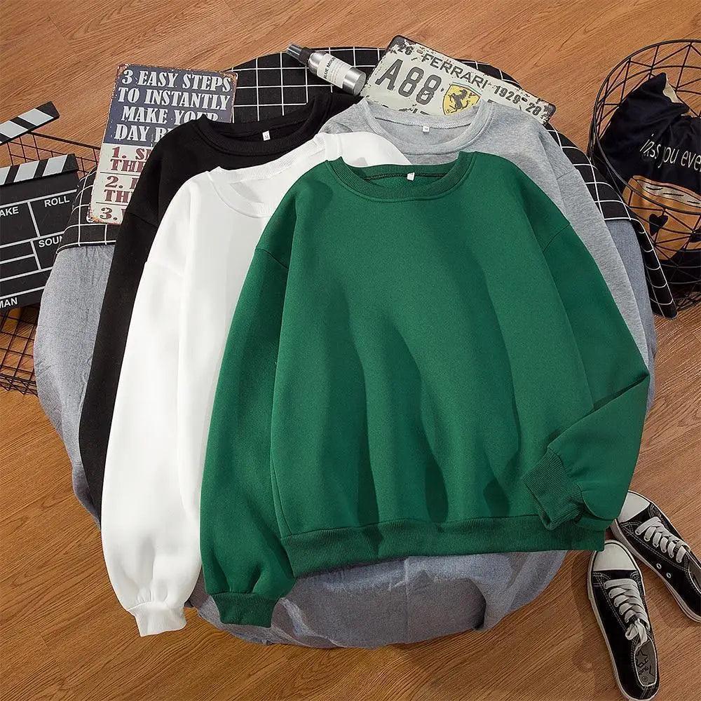Model wearing an oversized solid color crewneck streetwear hoodie in a casual setting