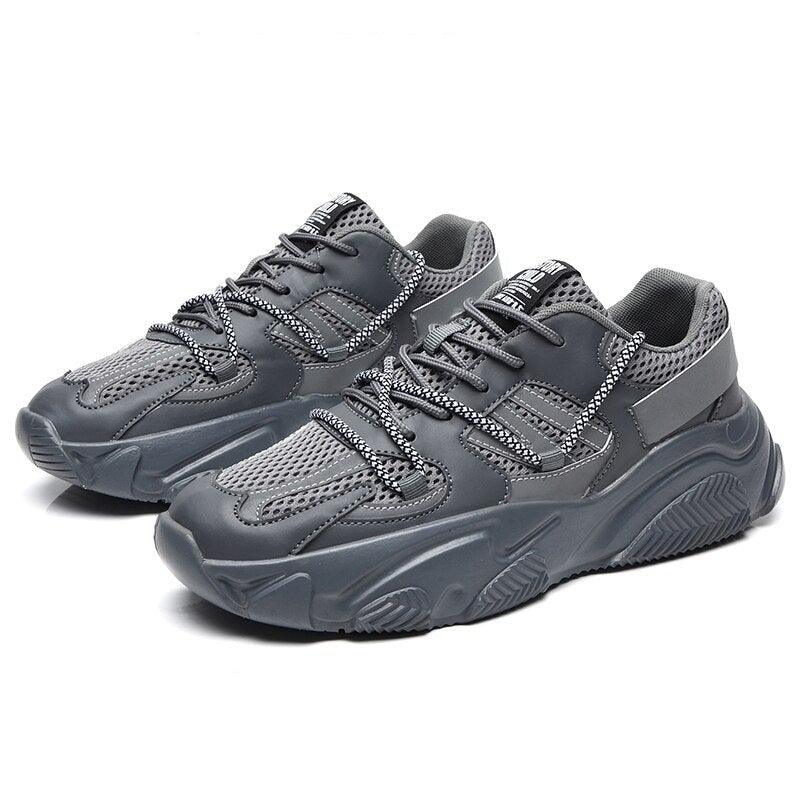 Men wearing stylish chunky monochrome mesh sports sneakers for gym and casual streetwear.
